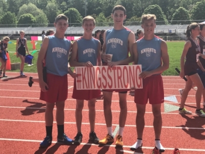 State Track runners holding KingsStrong sign